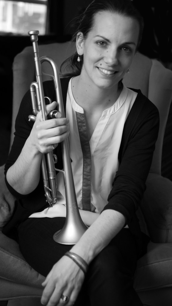 Rebecca Hennessy Black and White Headshot with trumpet